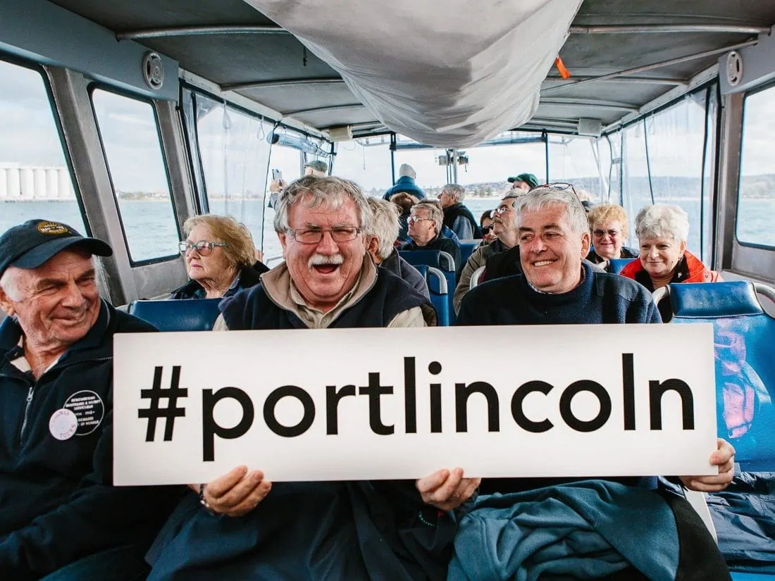 Tourists Holding Port Lincoln Hashtag Sign 0904