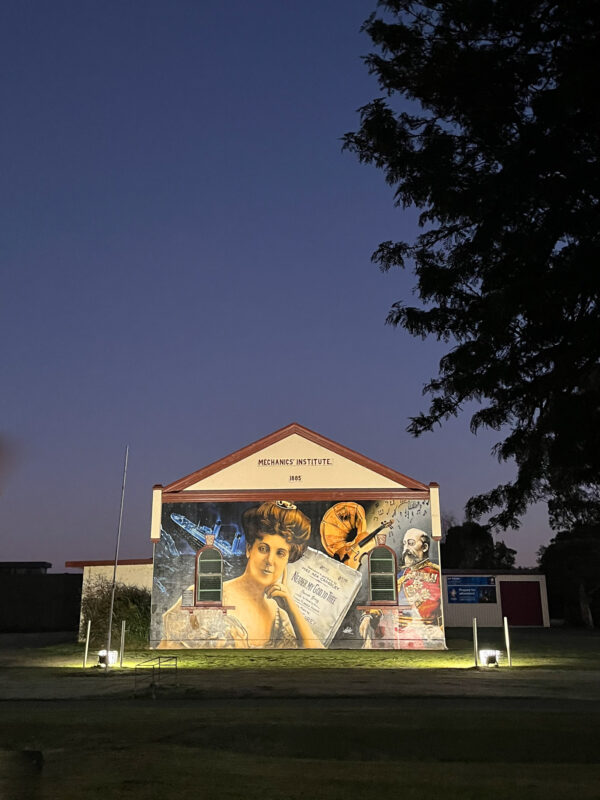 A mural on the side of a historic building